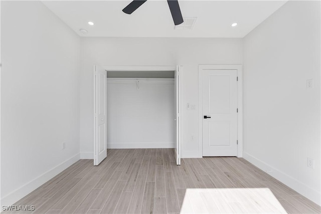 unfurnished bedroom featuring a closet, baseboards, ceiling fan, and light wood-style floors