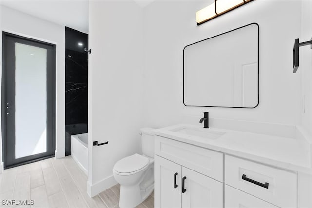 bathroom featuring toilet and vanity