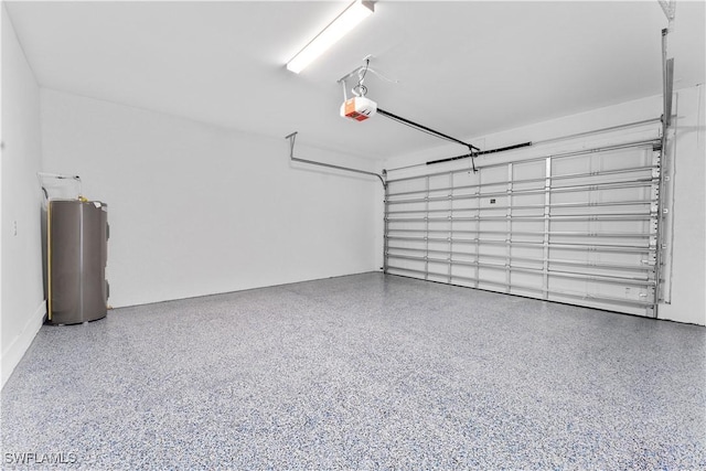garage featuring water heater and a garage door opener