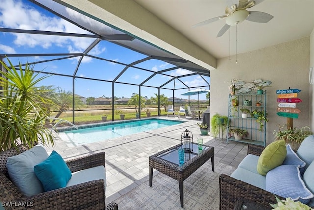outdoor pool with an outdoor hangout area, a patio area, and ceiling fan