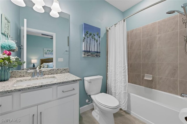 ensuite bathroom featuring vanity, shower / tub combo with curtain, toilet, baseboards, and ensuite bathroom