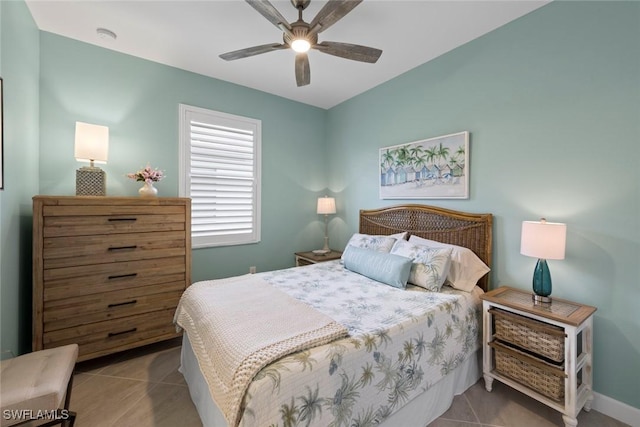 tiled bedroom with baseboards and ceiling fan