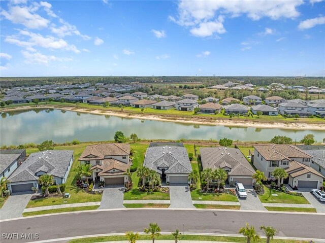 birds eye view of property featuring a water view and a residential view