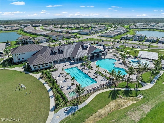 drone / aerial view featuring a water view and a residential view