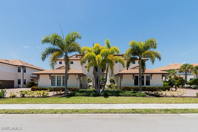 2173 Frangipani Cir Unit 102, Naples, FL 34120 - view of front of property featuring stucco siding and a front lawn