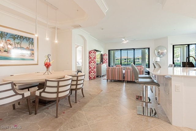 2173 Frangipani Cir Unit 102, Naples, FL 34120 - dining room with crown molding, plenty of natural light, arched walkways, light tile patterned flooring, and a ceiling fan