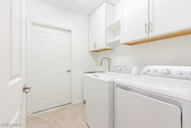 2173 Frangipani Cir Unit 102, Naples, FL 34120 - clothes washing area featuring independent washer and dryer, light tile patterned flooring, and cabinet space