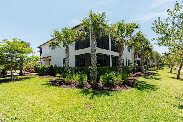 2173 Frangipani Cir Unit 102, Naples, FL 34120 - back of property with stucco siding and a yard