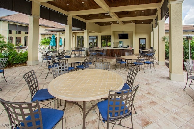 2173 Frangipani Cir Unit 102, Naples, FL 34120 - view of patio featuring outdoor dining space and a bar