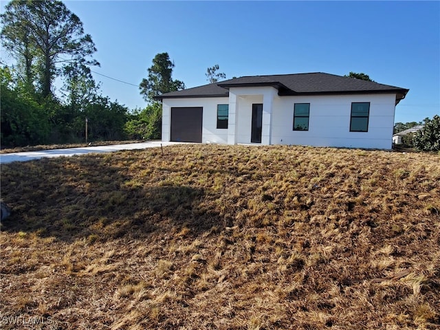 view of front of property featuring an attached garage and concrete driveway