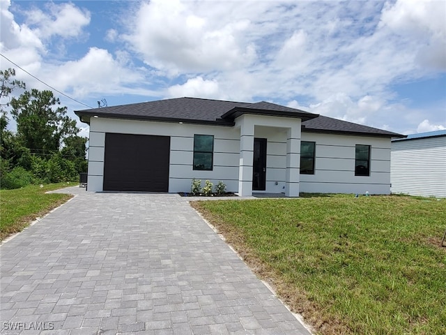 3117 35th St SW, Lehigh Acres, FL 33976 - view of front of property featuring decorative driveway, a front lawn, an attached garage, stucco siding, and roof with shingles