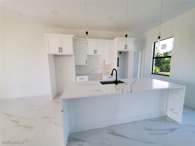 3117 35th St SW, Lehigh Acres, FL 33976 - kitchen featuring an island with sink, white cabinets, light marble finish flooring, and recessed lighting