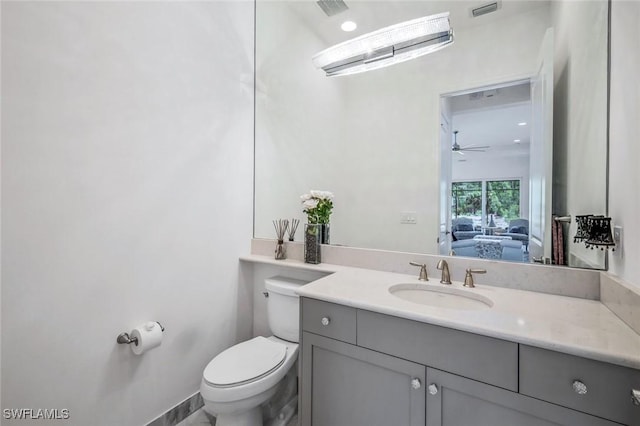 28616 Wharton Dr, Bonita Springs, FL 34135 - half bathroom with toilet, vanity, ceiling fan, and ensuite bathroom