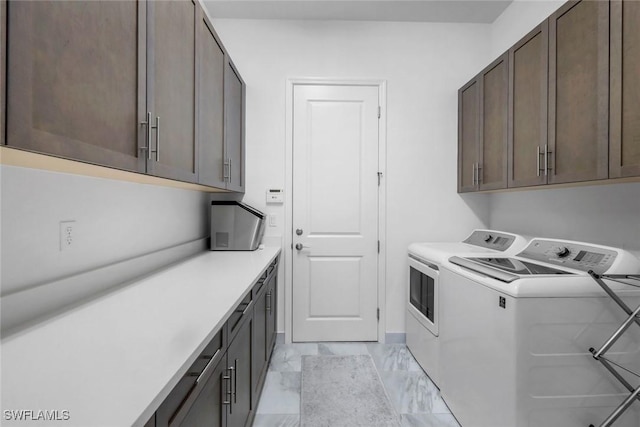 28616 Wharton Dr, Bonita Springs, FL 34135 - clothes washing area with independent washer and dryer, cabinet space, and light marble finish floors
