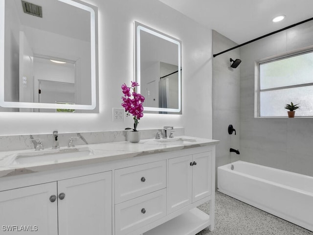 bathroom featuring double vanity,  shower combination, visible vents, and a sink