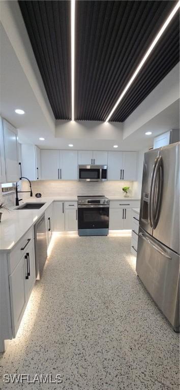 kitchen featuring a sink, white cabinetry, appliances with stainless steel finishes, and light countertops