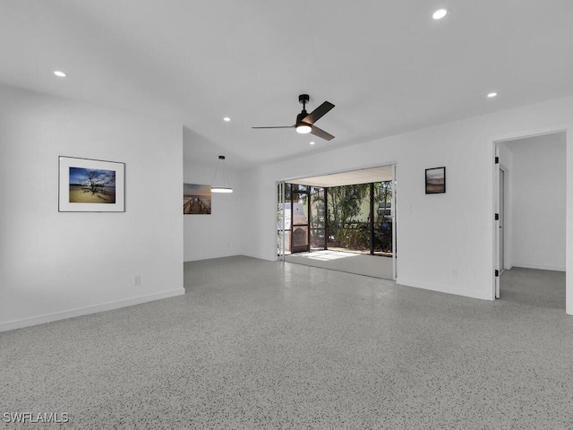 unfurnished living room with ceiling fan, recessed lighting, and speckled floor