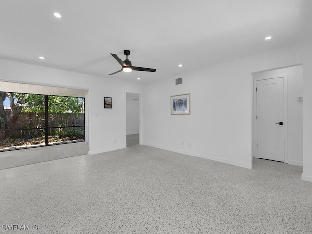 empty room featuring recessed lighting, a ceiling fan, speckled floor, and visible vents