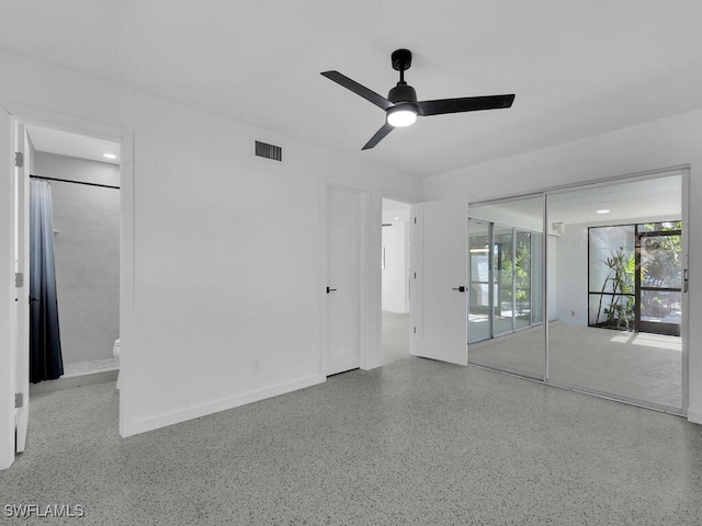 unfurnished bedroom with visible vents, a closet, ceiling fan, speckled floor, and ensuite bath