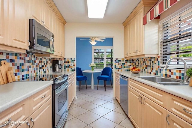 5914 Via Lugano Unit 2, Naples, FL 34108 - kitchen featuring appliances with stainless steel finishes, a sink, light brown cabinetry, light tile patterned floors, and ceiling fan