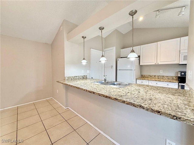kitchen featuring white appliances, white cabinetry, a sink, light tile patterned floors, and vaulted ceiling