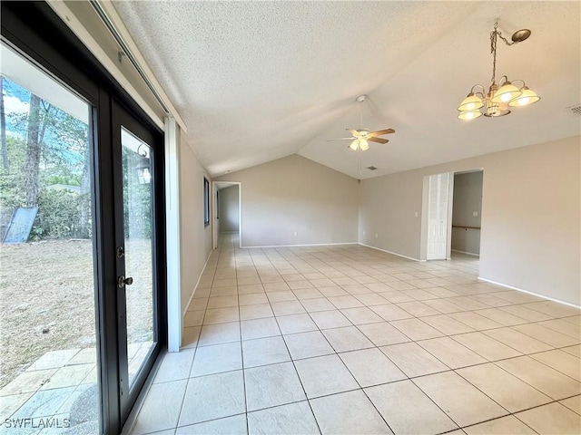 spare room with a textured ceiling, visible vents, baseboards, ceiling fan with notable chandelier, and lofted ceiling