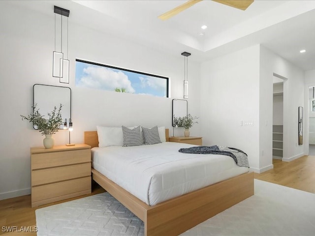 bedroom with light wood-style floors, baseboards, and recessed lighting