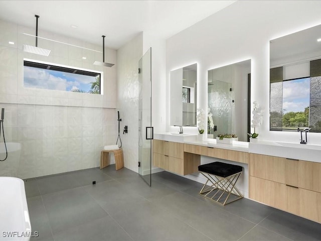 bathroom featuring double vanity, tile patterned floors, a sink, and tiled shower