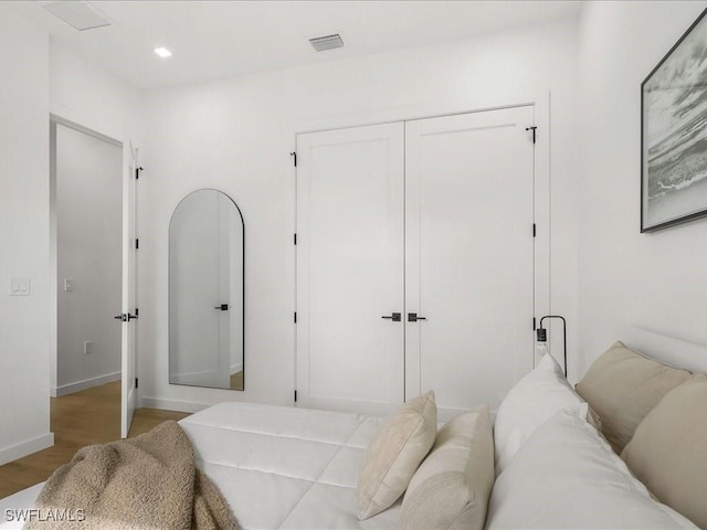 bedroom featuring visible vents, baseboards, a closet, light wood-style floors, and recessed lighting