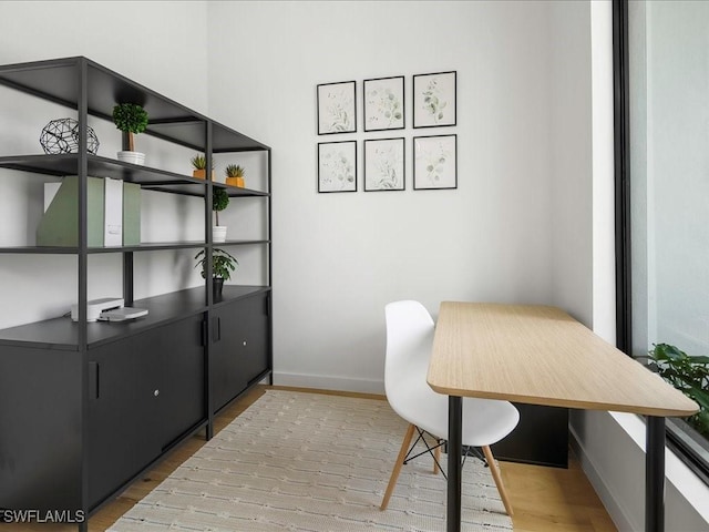 office area featuring baseboards and wood finished floors