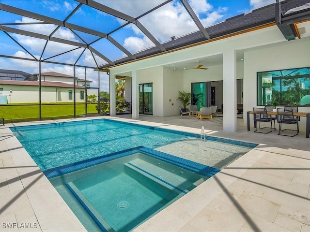 view of swimming pool with a ceiling fan, a lanai, a pool with connected hot tub, and a patio area