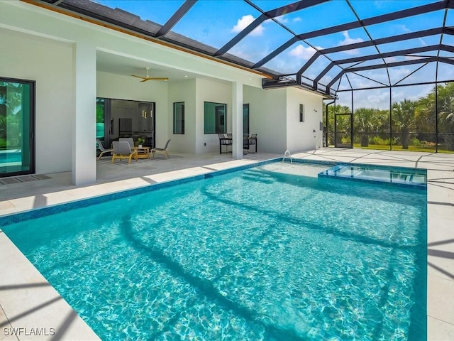 outdoor pool featuring ceiling fan, a patio area, and glass enclosure