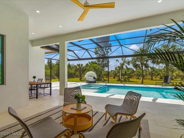 view of swimming pool with a patio, a pool with connected hot tub, and a lanai
