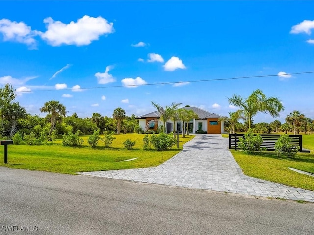 single story home with fence, a front lawn, and decorative driveway
