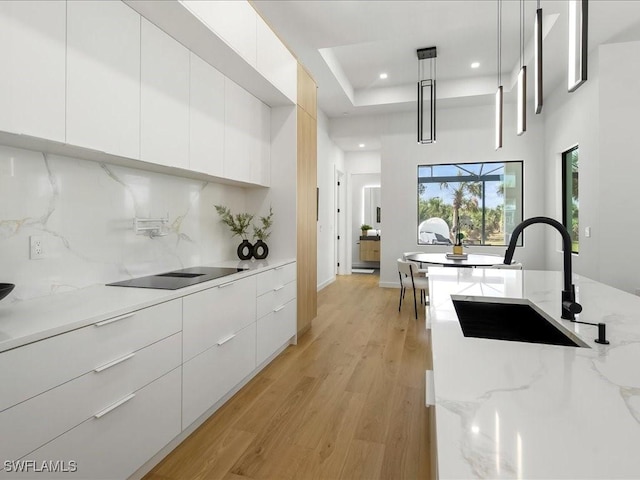 kitchen featuring white cabinets, recessed lighting, a sink, and modern cabinets