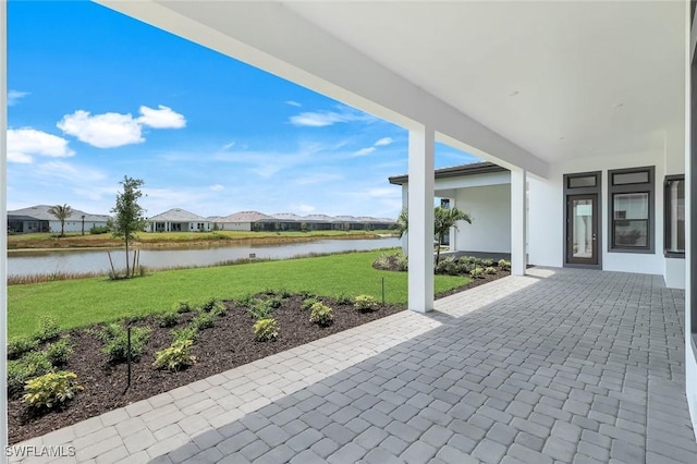 view of patio / terrace featuring a water view and a residential view