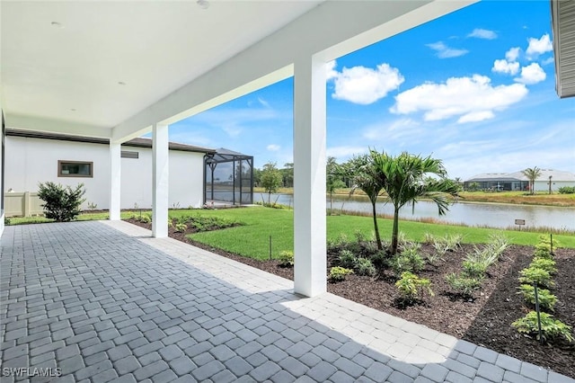 view of patio / terrace with a water view and glass enclosure