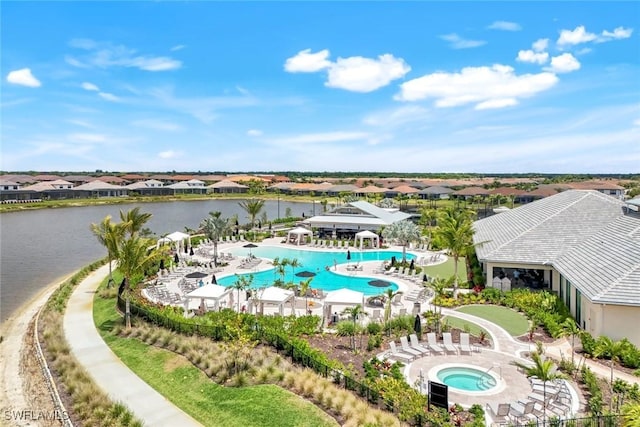 birds eye view of property with a water view and a residential view