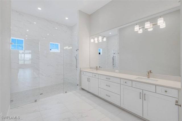 bathroom with a sink, a marble finish shower, and marble finish floor