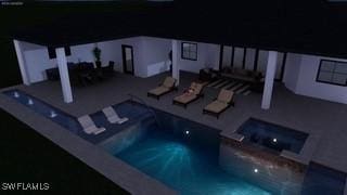 view of pool with a pool with connected hot tub