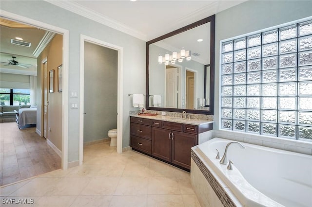 ensuite bathroom with ornamental molding, toilet, a garden tub, vanity, and ceiling fan