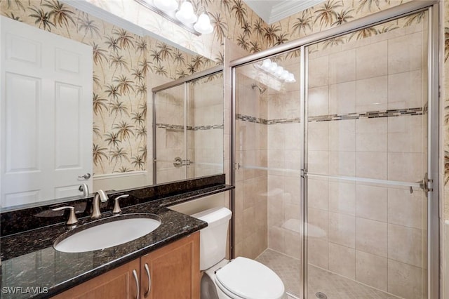 full bath featuring wallpapered walls, a shower stall, ornamental molding, toilet, and vanity