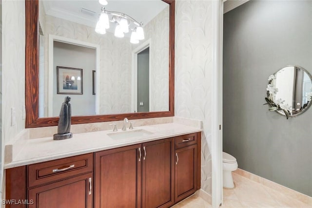 bathroom featuring vanity, toilet, ornamental molding, and wallpapered walls