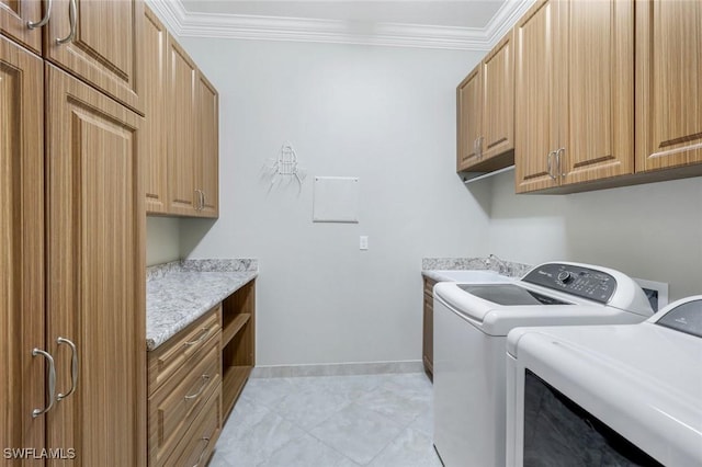 laundry area with cabinet space, independent washer and dryer, crown molding, baseboards, and light tile patterned floors