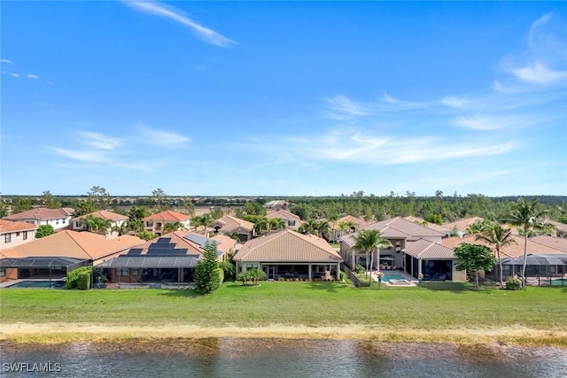 aerial view of residential area featuring a nearby body of water