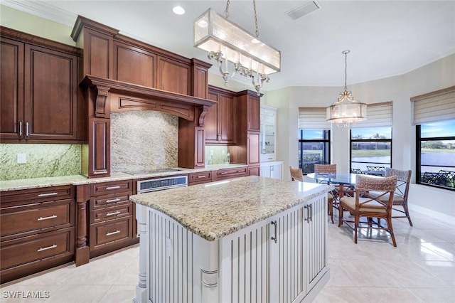 kitchen featuring a chandelier, light tile patterned floors, decorative backsplash, and light stone countertops