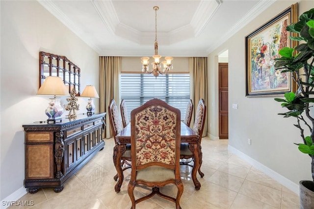 dining room with a chandelier, a tray ceiling, crown molding, light tile patterned floors, and baseboards