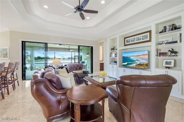 living area with a ceiling fan, built in features, crown molding, recessed lighting, and a raised ceiling
