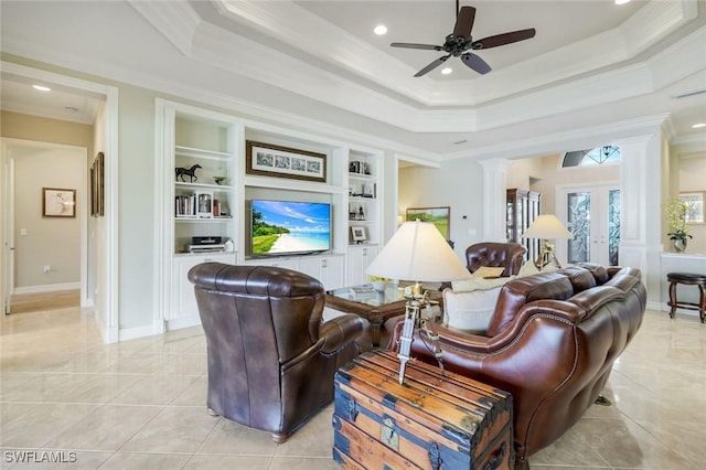 living area with crown molding, ornate columns, ceiling fan, a raised ceiling, and built in features