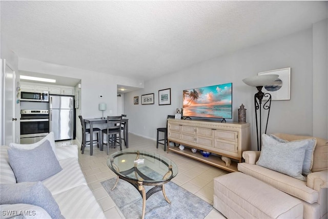 180 Seaview Ct Unit 814, Marco Island, FL 34145 - living area with a textured ceiling and baseboards